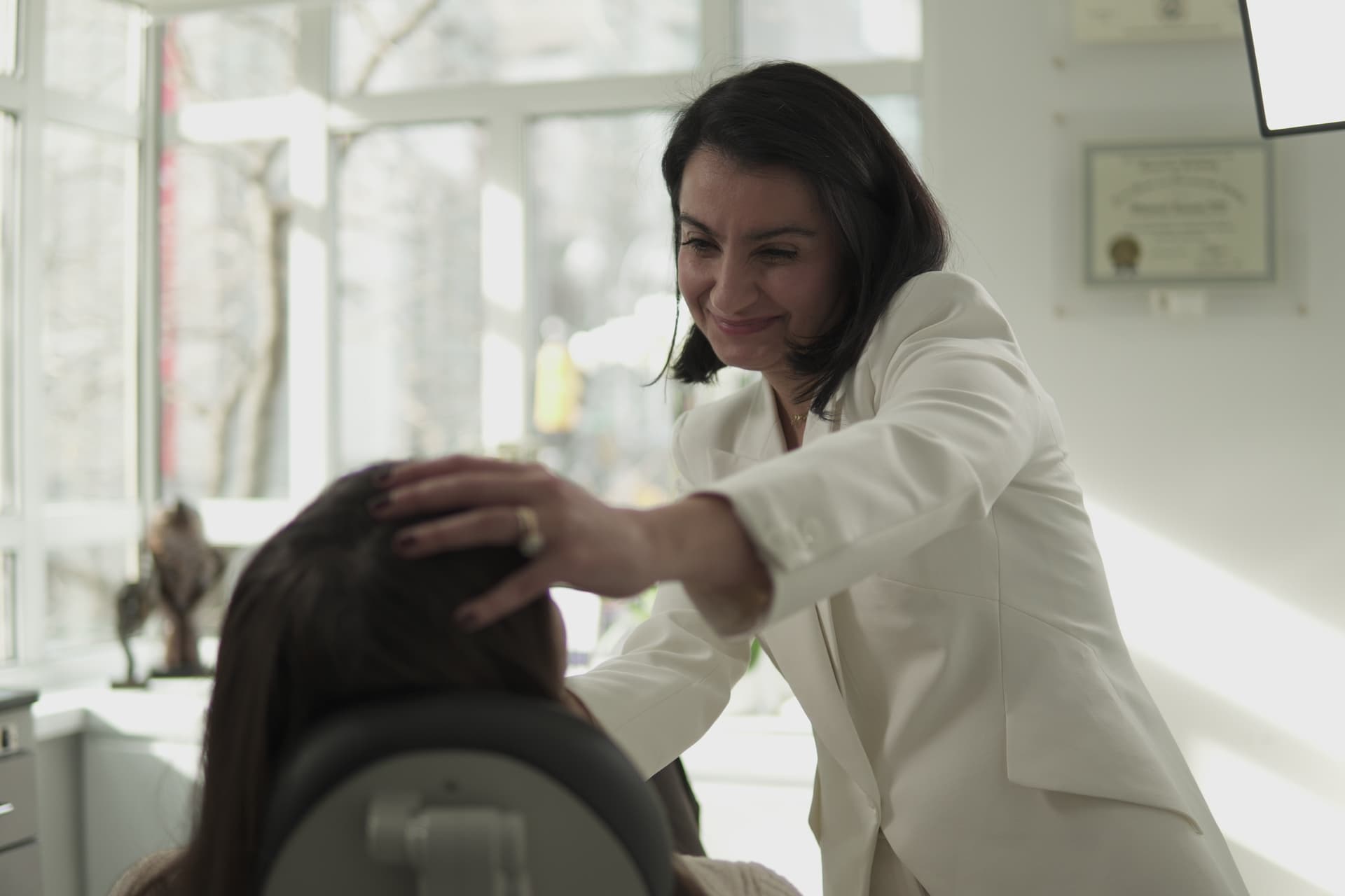 Dr. Nigar Ahmedli examining a patient at Saman Facial Plastic Surgery, New York